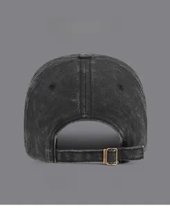 Detail of adjustable brass buckle on the back of a washed vintage grey baseball cap