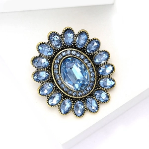 Spilla vintage a forma di girasole con strass blu su una base in bronzo