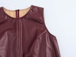 Detail of round neck and back zipper on burgundy faux leather sleeveless top