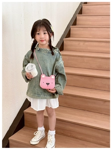 Toddler girl wearing pink teddy bear crossbody bag with denim top and white pleated skirt