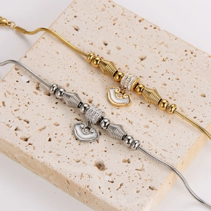 Snake chain bracelets with Ruyi lock pendant in gold and silver plating on stone stand