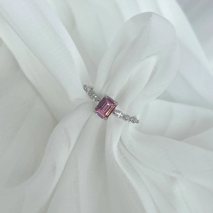 Detail of S925 silver ring with pink emerald-cut gemstone nestled in white soft tulle