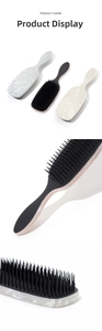 Detail of detangling hair brushes with elegant marble texture handles in three colors