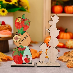 Detailed view of autumn wooden pumpkin ornaments with sunflower and gnome designs
