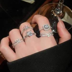 Close-up of sparkling heart and geometric zircon rings on hand with a luxury finish
