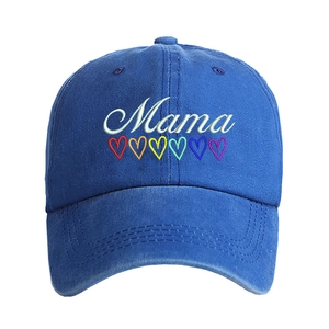 Detailed view of white Mama embroidery and colorful hearts on navy washed cotton baseball cap