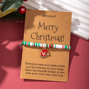 Christmas clay bead bracelet on kraft card with Santa Claus and snowflake pendants