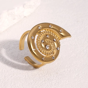 Detailed view of gold spiral ring with sparkling zircons and adjustable band