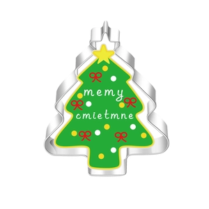 Close-up of a stainless steel Christmas tree cookie cutter with festive green and red design
