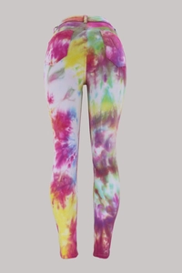 Detail view of colorful tie-dye denim pants featuring slim fit cut and back pockets