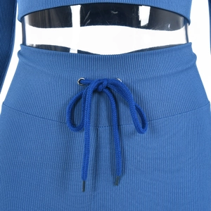 Close-up of blue ribbed knit fabric texture and drawstring waistband on casual suit