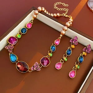 Detailed macro of vintage French flower earrings with colorful crystals and pearls