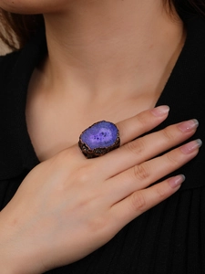 Detail view of large purple crystal raw stone ring with antique bronze textured wide band