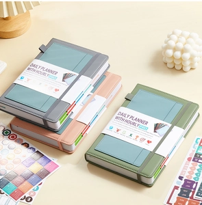 Detailed close-up of colorful PU leather daily planners with elastic bands and paper sleeves