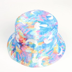 Detail of tie-dye bucket hat featuring butterfly and moon prints on canvas fabric