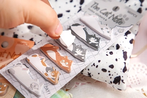 Close-up of cute cat index stickers being peeled, showing adhesive quality and thickness