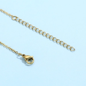 Detail of the golden necklace lobster clasp and adjustable extension chain