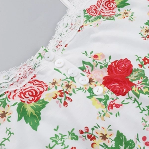 Detail of floral lace trim neckline with small white buttons on knit camisole top