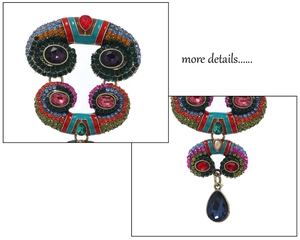 Detailed close-up of retro vintage brooch with multi-color rhinestones and gemstones