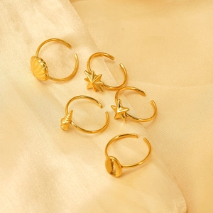 Minimalist gold plated starfish and shell open ring set on elegant silk fabric