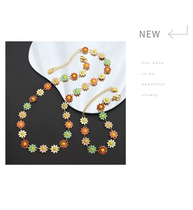 Detailed set of colorful daisy floral necklace and bracelet on a black background