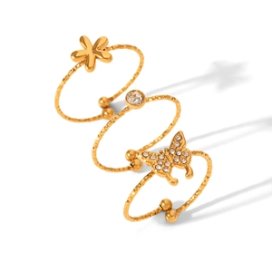 Detailed view of 3-piece gold stainless steel ring set with flower and butterfly charms