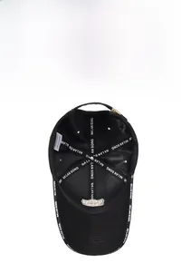 Detail view of the black baseball cap interior with polyester lining and logo taping