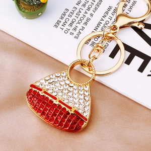 Detail shot of golden lobster clasp and rhinestone encrusted handbag keychain charm