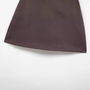 Flat lay of minimalist dark brown skirt pants with detailed hem stitching and fabric texture