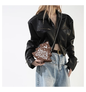 Detail of Christmas tree shaped leather crossbody bag with deer pattern and chain strap