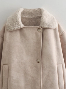 Detail of beige faux suede jacket showing soft shearling collar and button closure