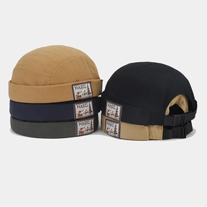 Detail of vintage canvas docker caps featuring adjustable buckles and MASIC brand patches