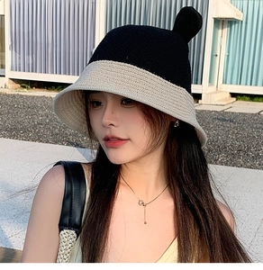 Close-up of the woven texture and cute 3D ears on a black and white straw bucket hat