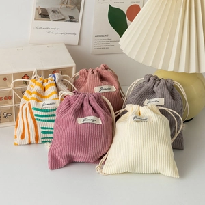 Multi-color corduroy drawstring pouches for makeup storage in soft home setting