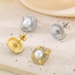 Detail of 18k gold and silver oval earrings with pearls and surrounding crystals