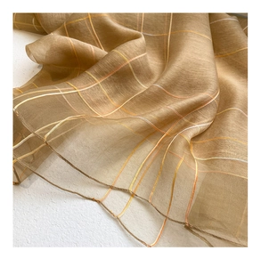 Detail of sheer brown silk wool scarf featuring fine yellow and orange pinstripe patterns