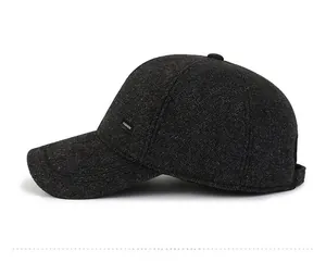 Close-up of a warm grey wool baseball cap with side fashion label and ear protection