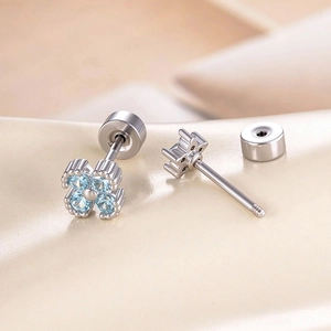 Silver clover stud earrings with light blue zircons shown in high detail layout