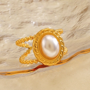 Vintage gold stainless steel ring featuring a large oval pearl and braided textures