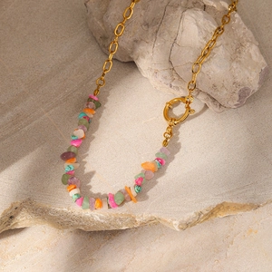 Close-up of bohemian turquoise stone necklace with irregular crystals and gold-plated chain
