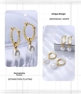 Detail view of vintage French style gold earrings with elegant white teardrop pearls