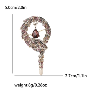 Elegant rhinestone snake brooch with teardrop gemstone detail on white background