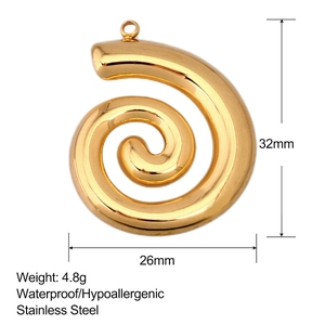Macro detail of golden spiral pendant showing 32mm size and stainless steel texture