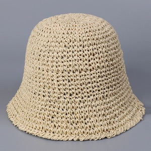 Close-up of the beige hand-woven crochet bucket hat showing the detailed straw texture