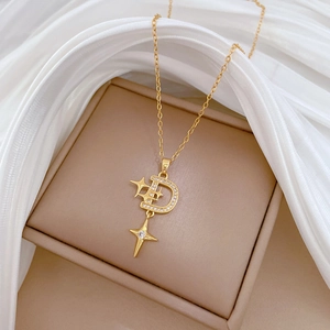 Luxurious gold starburst D-letter necklace with pavé crystals on a silk display