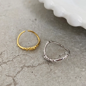 Close-up of stacked bead texture on gold and silver adjustable minimalist rings