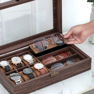 Detail of walnut wood finish organizer with clear glass lid and soft brown lining