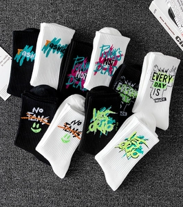 Close-up of cotton crew socks featuring street-style graffiti prints and ribbed texture