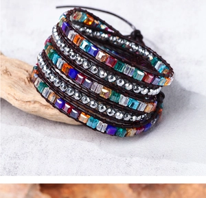 Detail of bohemian wrap bracelet with multi-colored crystals and silver beads on leather