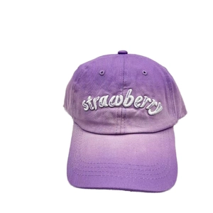 Close-up of strawberry 3D embroidery on purple gradient washed cotton baseball cap